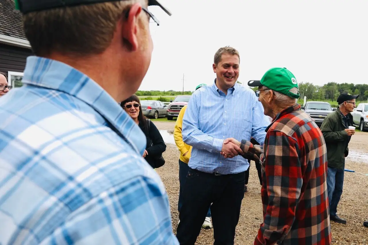Politician greeting locals at a gathering in Debden, 2019